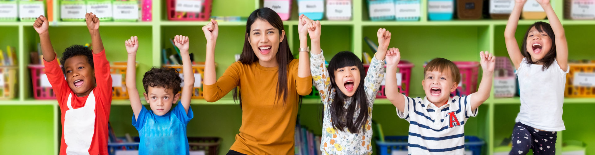 children smiling and raise up their arms