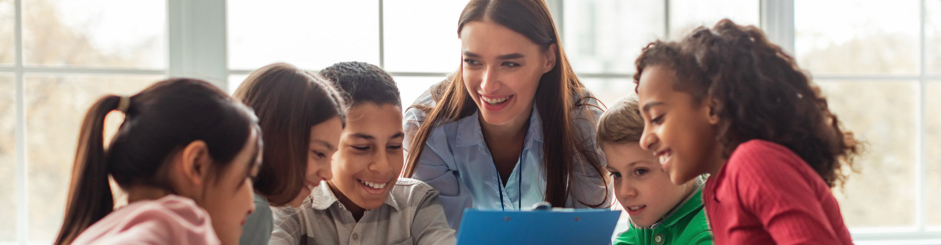 a female teacher teaching children in class